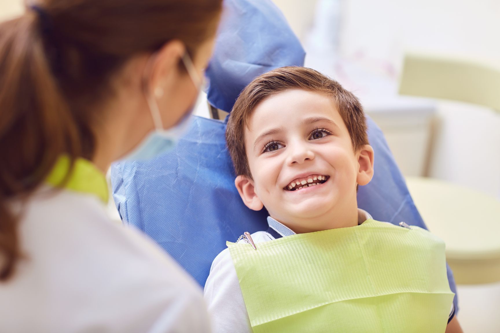 Dentist helping child get comfortable for sedation treatment in Maricopa, AZ